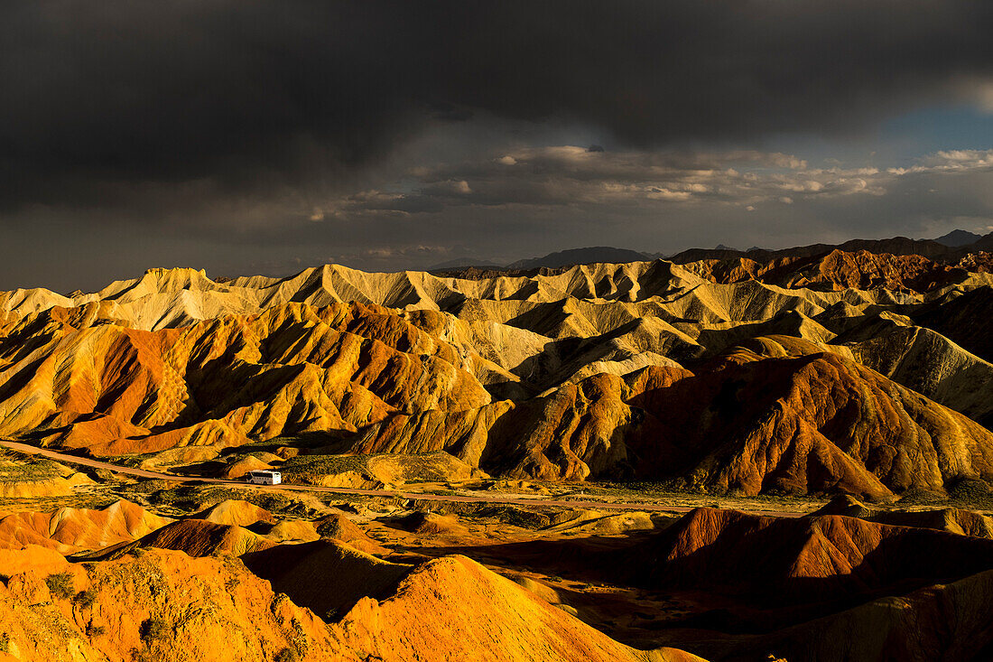 Tourist bus during sunset at the Rainbow Mountains of Zhangye Danxia National Geological Park