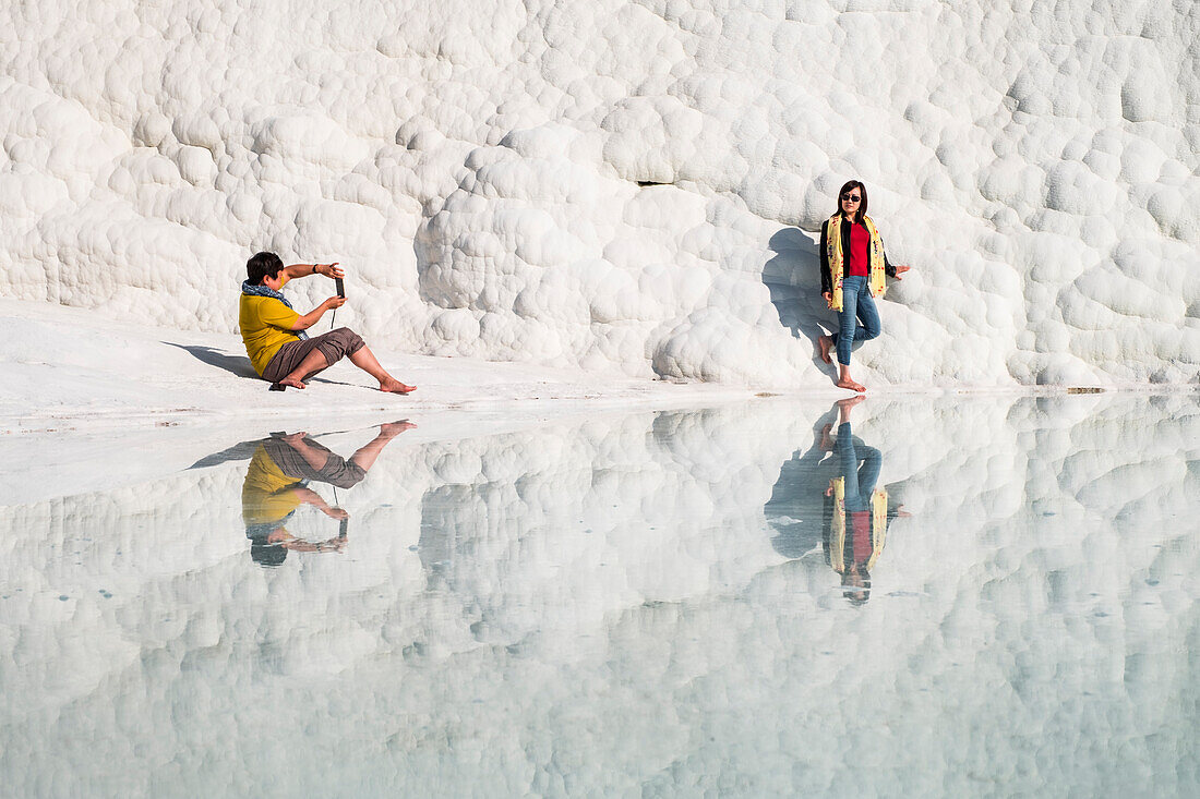 Travertine terrace formations at Pamukkale and tourists