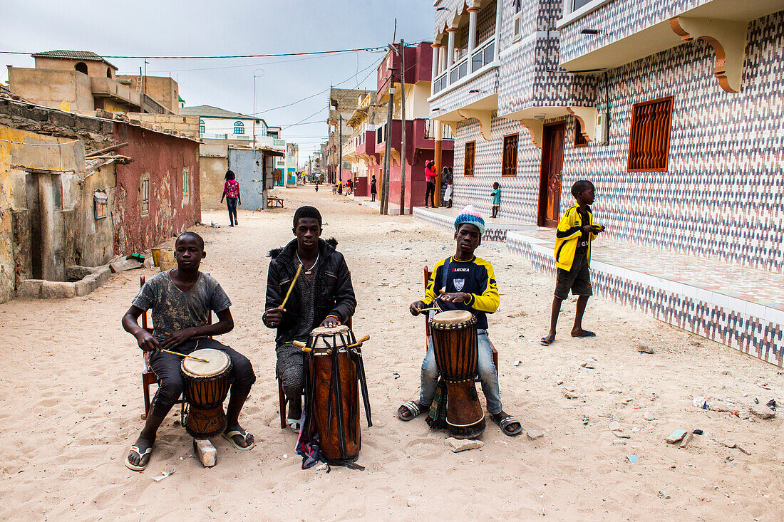 Boys playing drums on the streets of Saint-Louis