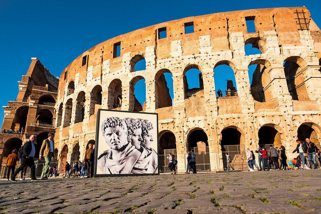Tourists outside the Colosseum or Coliseum, the most famous landmark from ancient Rome