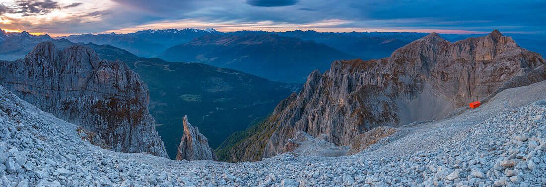 Alpine sunset on the scree slope overlooking the Adamello National Park mountains, as seen from Fratelli Bonvecchio mountain hut. Dolomiti di Brenta, Trento, Trentino Alto Adige, Italy.