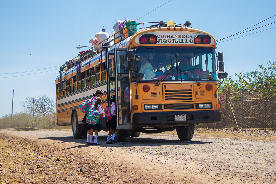Kinder steigen in den Schulbus in Jiquilillo, Chinandega, Nicaragua