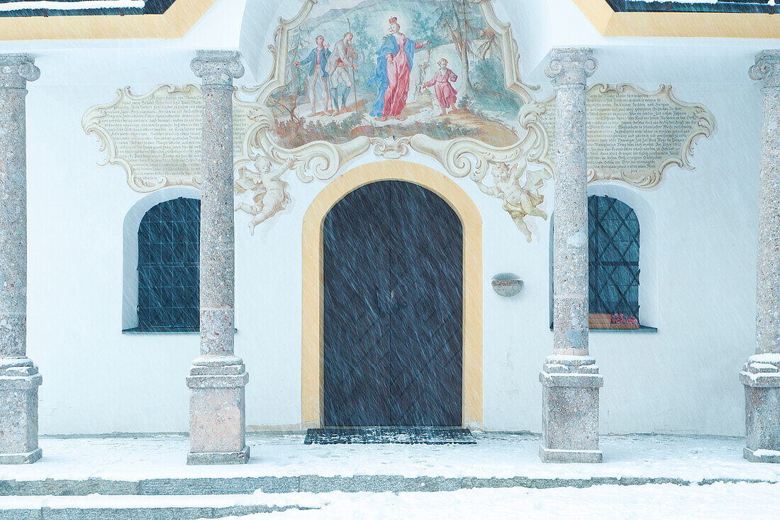 The white facade of Heiligwasser Church on a snowy day, Igls, Innsbruck, Tyrol, Austria, Europe