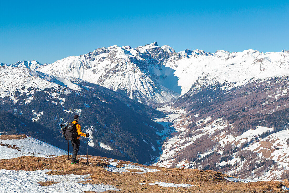 A mountaineer enjoying the view over Obernberg Valley and the Tribulaun mountains, Padauner Kogel, Innbsruck Land, Tyrol, Austria, Europe