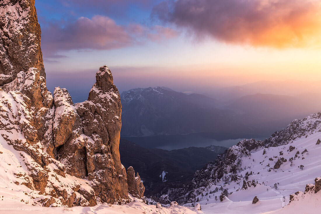 Torrione del Cinquantenario at sunset after a snowfall with view on Como Lake. Grignetta, Grigne group, Lake Como, Lombardy, Italy, Europe