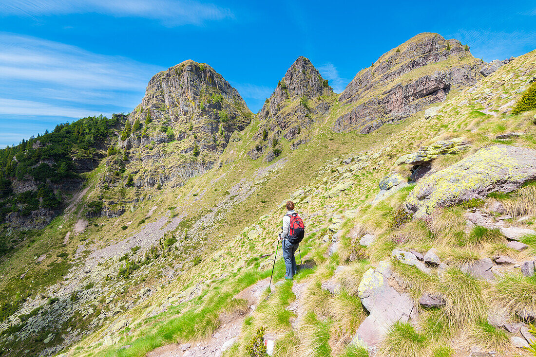 Hiker under Tre Pizzi, Val Brembana, Alpi Orobie, province of Bergamo, Lombardy, Italian alps, Italy