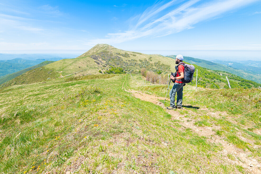 Hiker look Mount Ebro from Mount Chiappo, Staffora valley, Oltrepo Pavese, Province of Pavia, Apennines, Lombardy, Italy