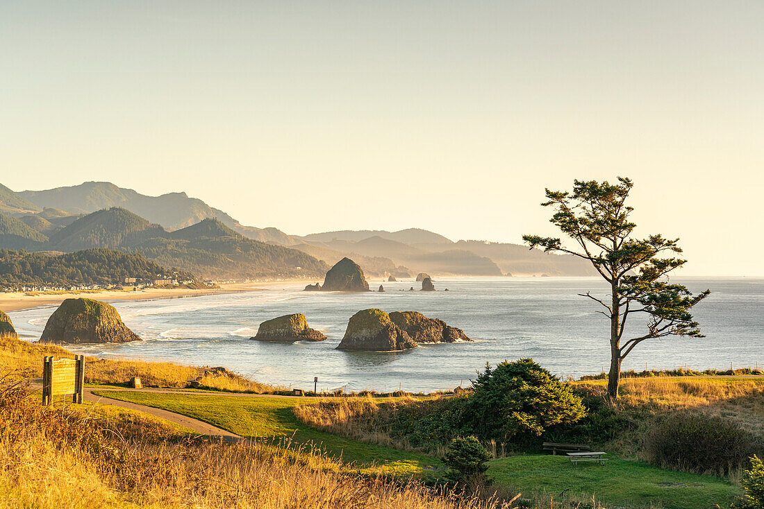 View of rock formations and Haystack Rock of Cannon Beach from Ecola State Park. Clatsop county, Oregon, USA.