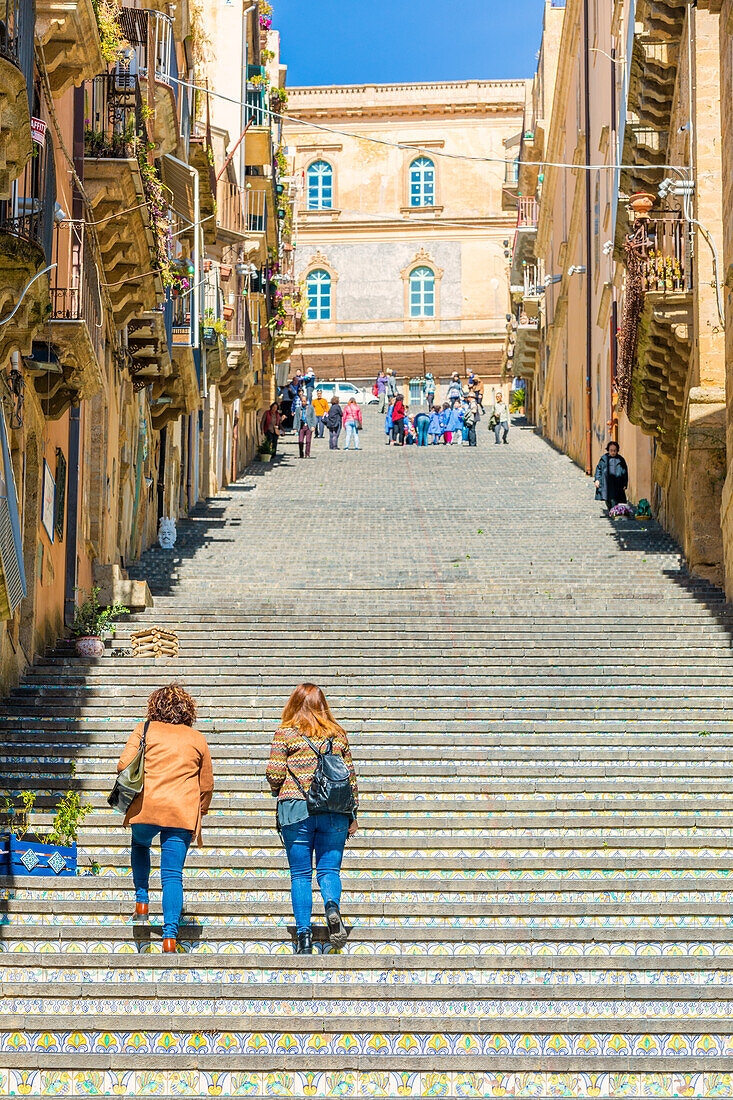 Close up of tourists climbing the tiled staircase of Santa Maria del Monte, Caltagirone, Catania Province, Sicily, Italy