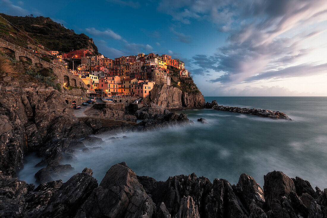 Long exposure at sunset on the cliff of the village of Manarola, Cinque Terre National Park, municipality of Riomaggiore, La Spezia province, Liguria district, Italy, Europe