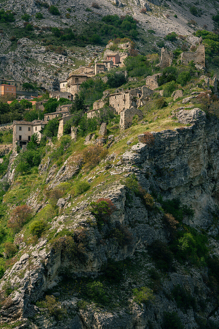 Ancient medieval village perched on an overhanging rock. Play of light and shadow with clouds and sunlight. Pescosansonesco, Pescara province, Abruzzo, Italy