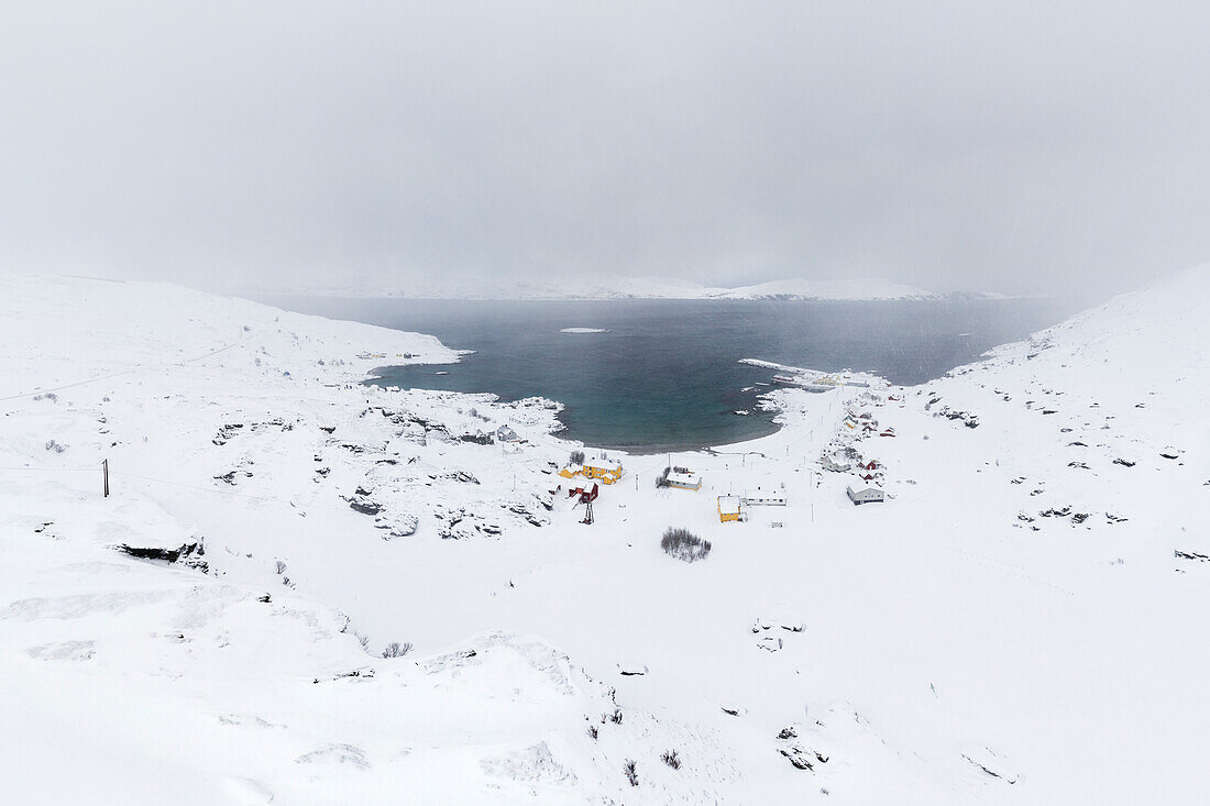 Coastal village of Breivik covered with snow during the cold arctic winter (Soroya Island, Hasvik, Troms og Finnmark, Norway)