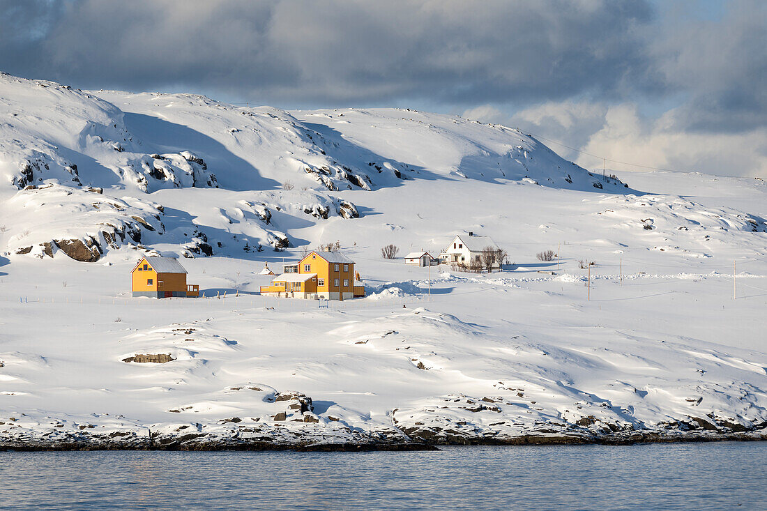 Hasvik Village: houses covered with snow during the cold arctic winter (Soroya Island, Troms og Finnmark, Norway)