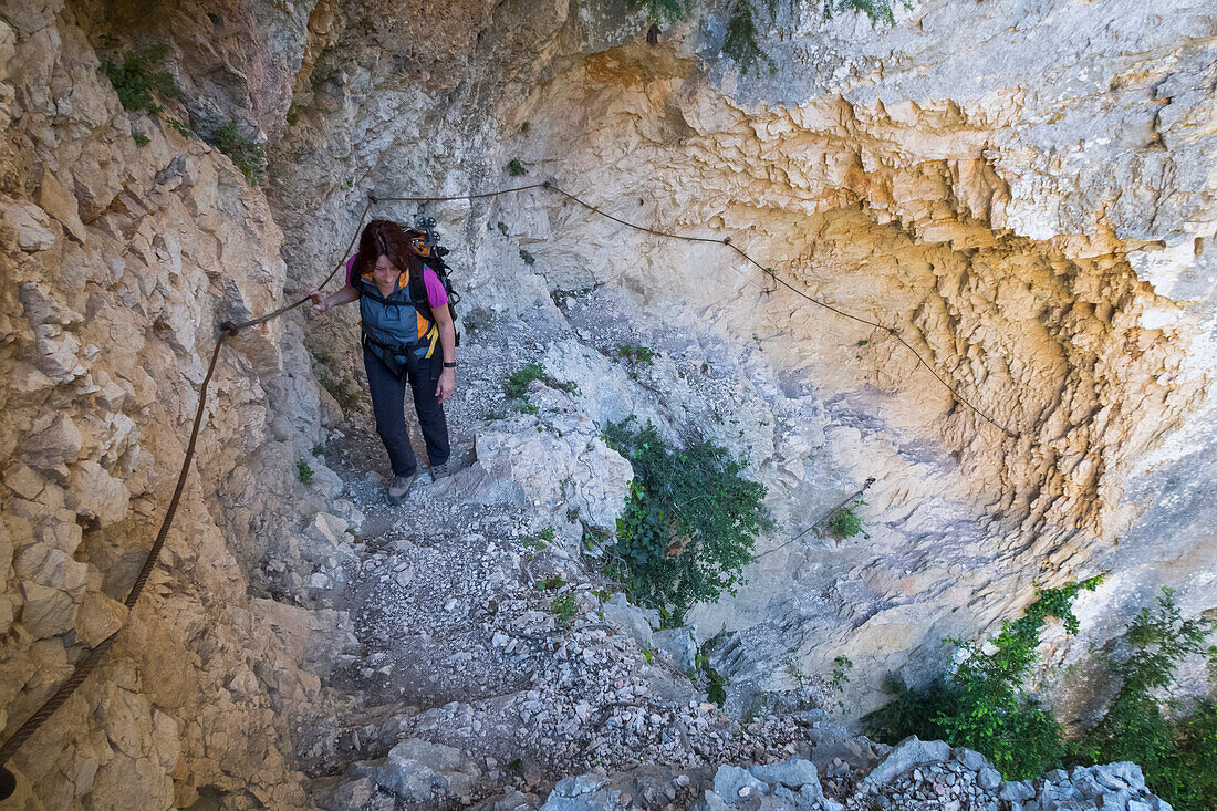 The Vidal footpath: a girl is climbing up from the Verdon Gorge (Var department, Provence-Alpes-Côte d'Azur, France, Europe) (MR)
