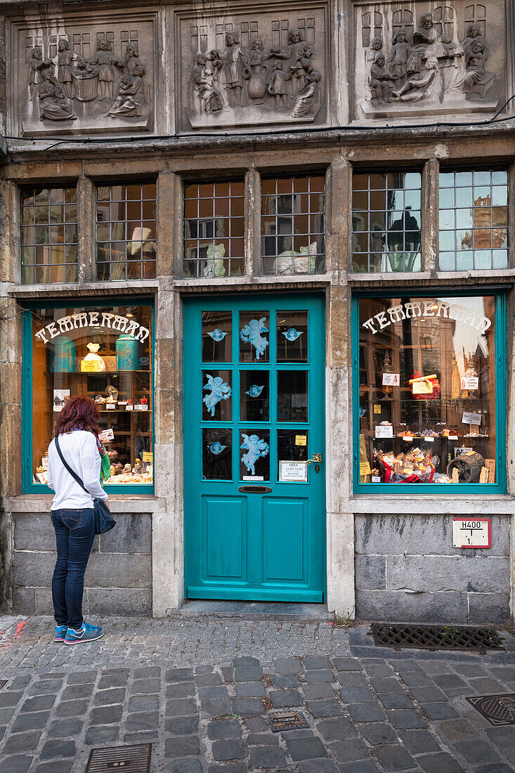 A woman is looking at a famous sweets shop (Ghent, East Flanders, Flemish Region, Belgium, Europe) (MR)