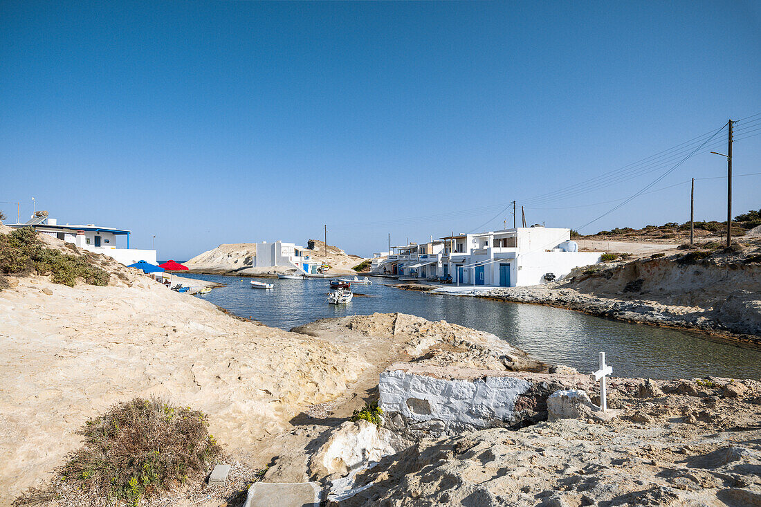 The small fishing village of Agios Konstantinos and its hold cave Church (Plaka, Milos Island, Cyclades Islands, Greece, Europe)