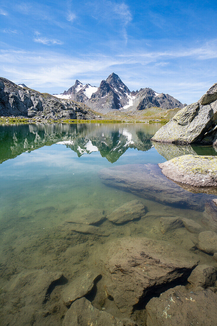 The green lake and the Grand Assaly reflected in the background. Gren lake, Deffeyes refuge, La Thuile, Aosta Valley, Italy, Alps, Europe.