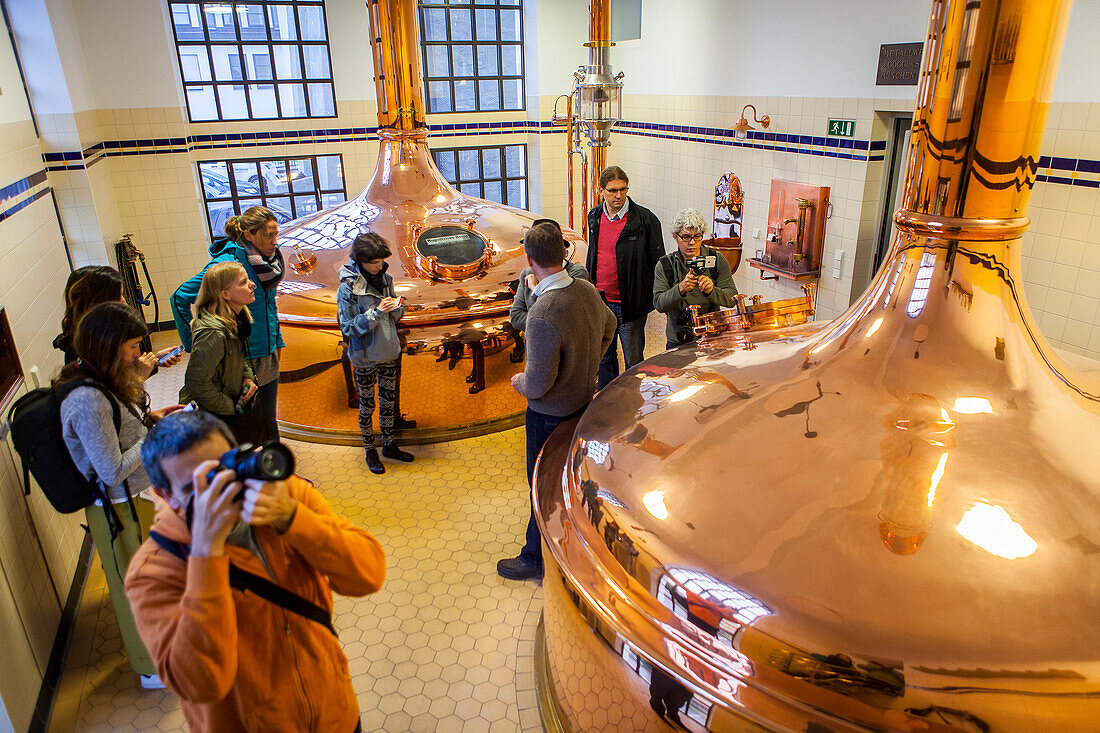 Visitors, Brewing room with mash tun copper tanks, in Augustiner Brau, brewery, Salzburg, Austria