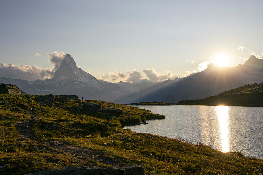 Switzerland, Zermatt, Hiker looking at the Matterhorn near lake Stellisee and sunset