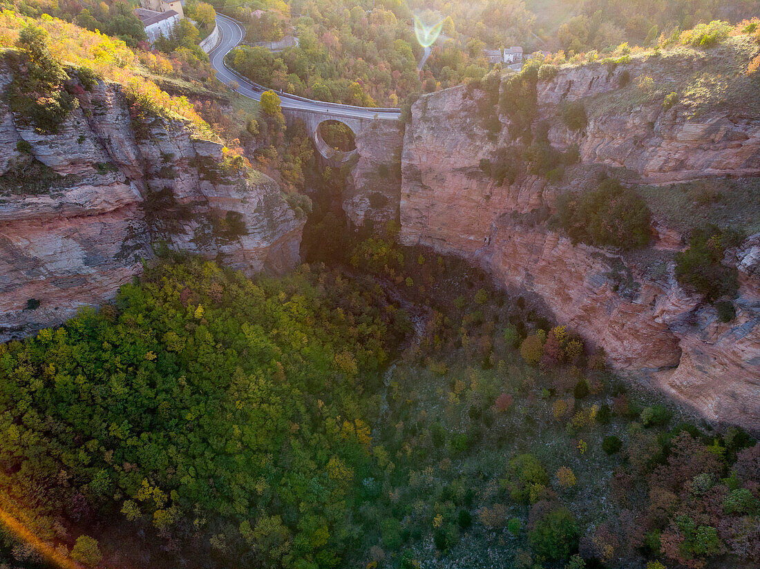 Italy, Umbria, Apennines, Scheggia, Aerial view of Scheggia pass and Ponte a botte bridge in Autumn