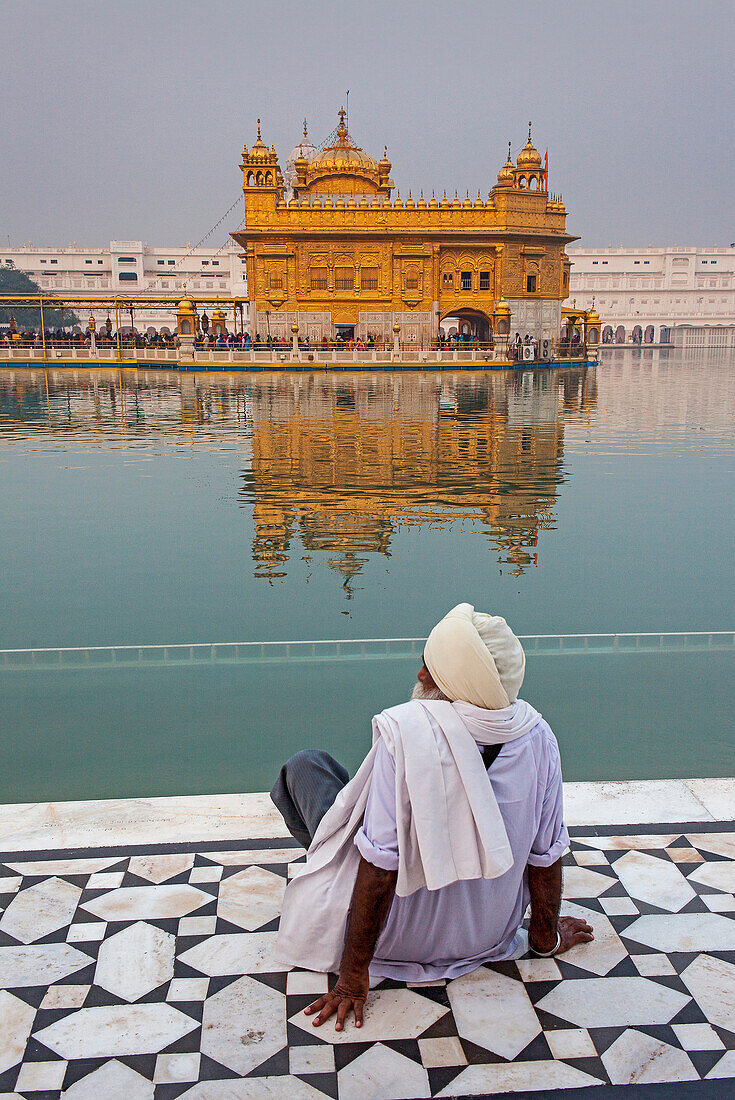 pilgrim and sacred pool Amrit Sarovar, Golden temple, Amritsar, Punjab, India