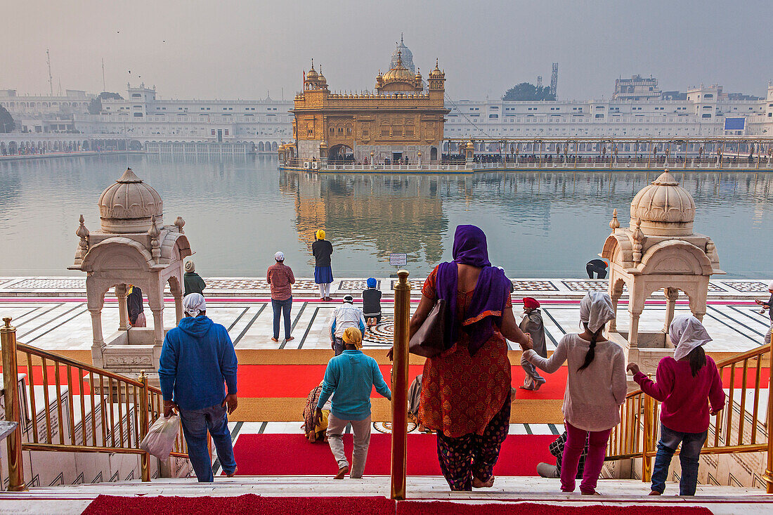 pilgrims and sacred pool Amrit Sarovar, Golden temple, Amritsar, Punjab, India