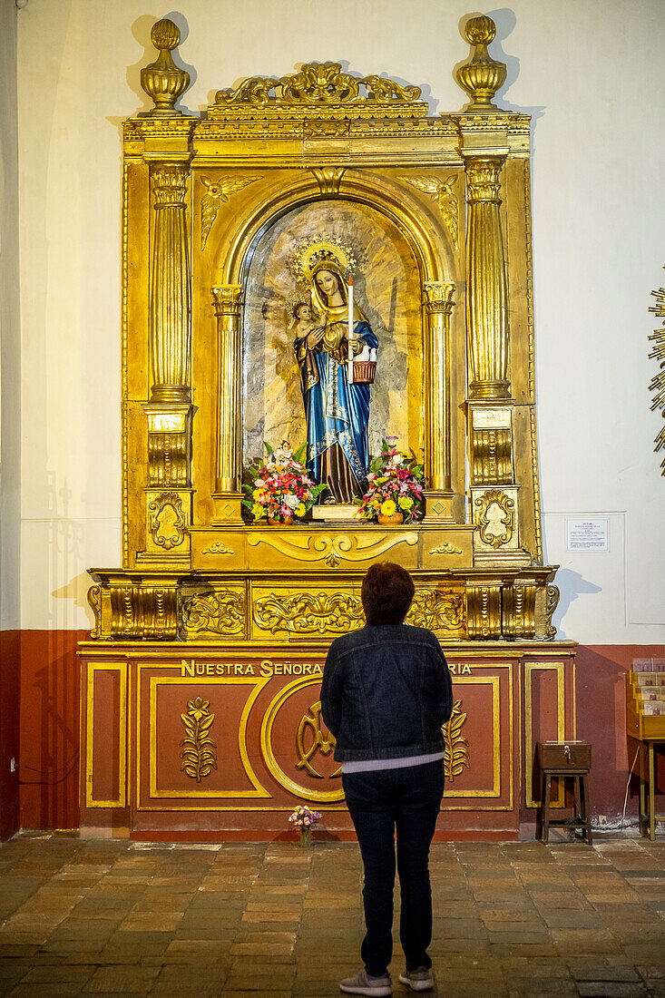 Woman praying, Iglesia de Nuestra Señora de la Candelaria, church, Bogota, Colombia