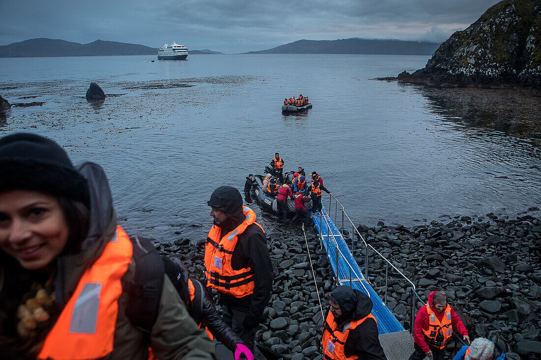 The explorers disembark at Cape Horn, Tierra de Fuego, Patagonia, Chile