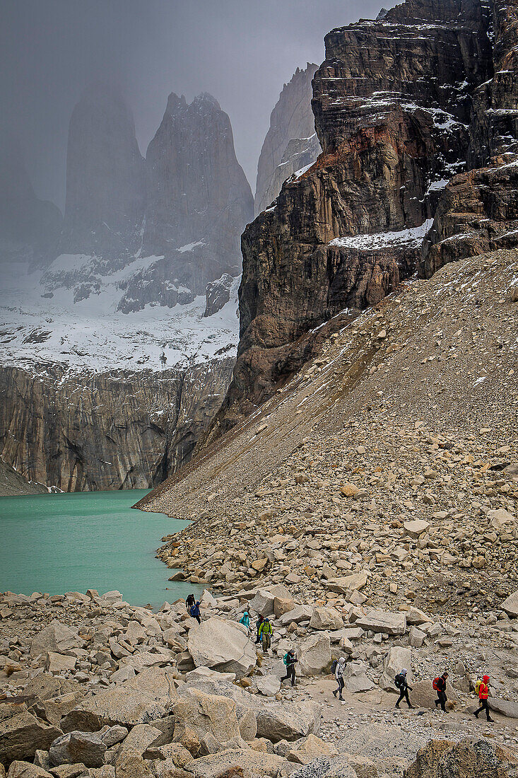 Hikers, in Mirador Base Las Torres. You can see the amazing Torres del Paine, Torres del Paine national park, Patagonia, Chile