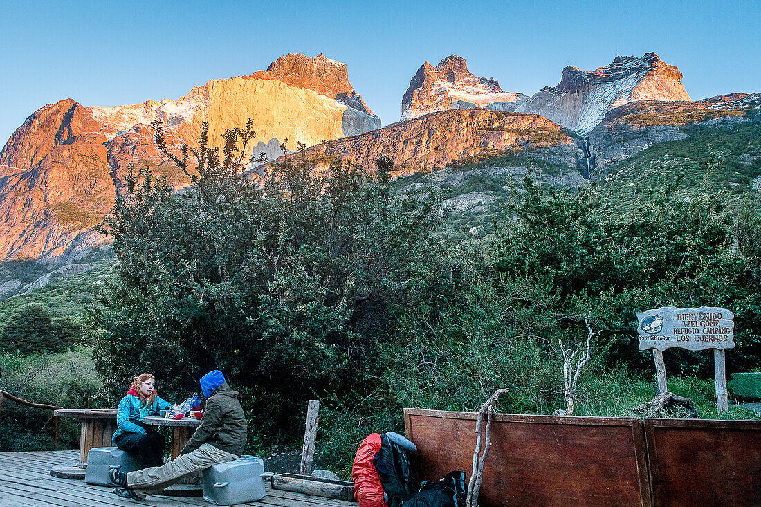Hikers resting in Cuernos refuge, You can see the amazing Cuernos Del Paine, Torres del Paine national park, Patagonia, Chile