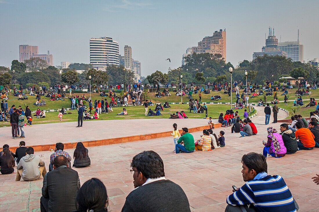 Menschen beim Entspannen im Park des Connaught Place, Delhi, Indien