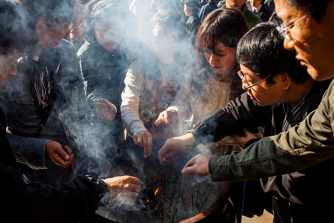 People burning incense, in Kiyomizu-dera temple, Kyoto. Kansai, Japan.