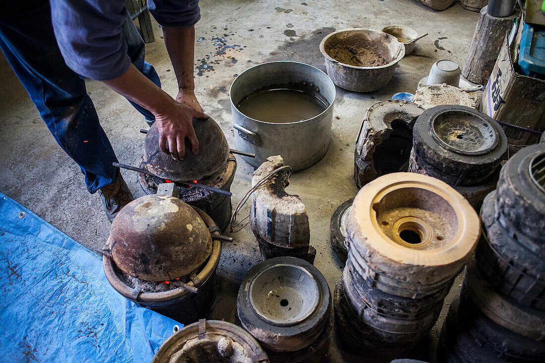 Takahiro Koizumi is preparing spoon to load molten iron, that will put in a molds to make a iron teapot or tetsubin, nanbu tekki, Workshop of Koizumi family, Morioka, Iwate Prefecture, Japan