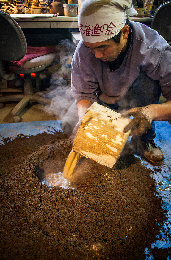 Takahiro Koizumi is making mud to build a molds to make a iron teapot or tetsubin, nanbu tekki, Workshop of Koizumi family,craftsmen since 1659, Morioka, Iwate Prefecture, Japan