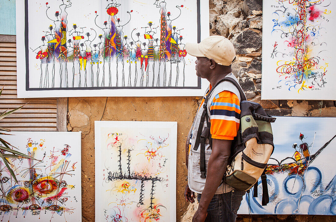 Tourist, in Workshop of Fallow painter, Goree island, near Dakar, Senegal