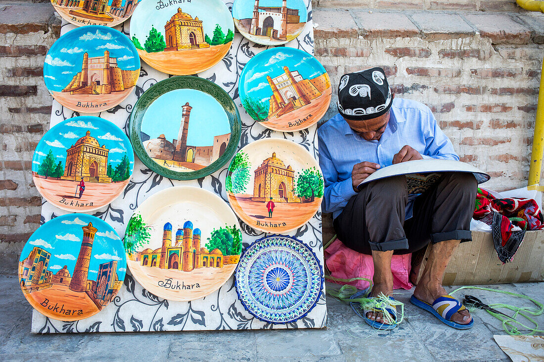 Craftsman selling traditional uzbek pottery, Bukhara, Uzbekistan