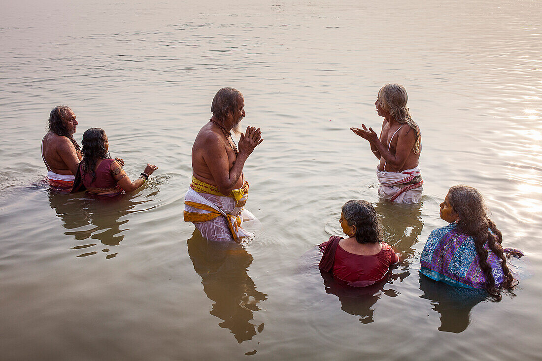 Pilgrims praying and bathing, in the ghats of Ganges river, Varanasi, Uttar Pradesh, India.