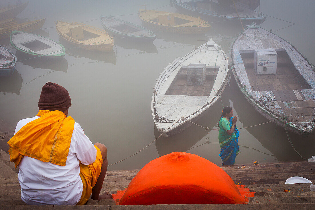 Pilgrims praying, in the ghats of Ganges river, Varanasi, Uttar Pradesh, India.