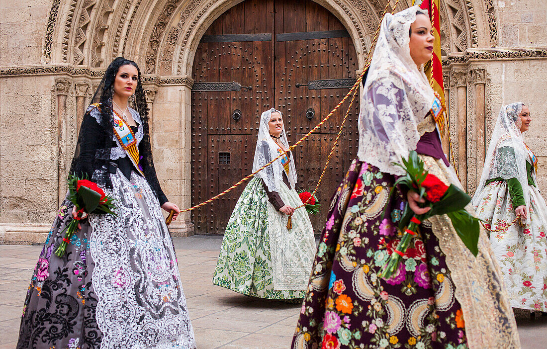 Flower offering parade,People with Floral tributes to `Virgen de los desamparados´, Fallas festival, Plaça de l´Almoina square,Valencia