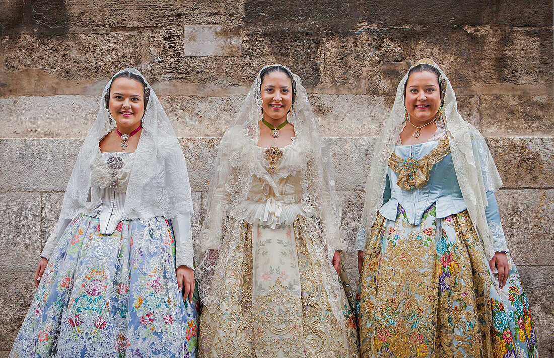 Women in Fallera Costumes during Flower offering parade, tribute to `Virgen de los desamparados´, Fallas festival, Plaza de la Virgen square,Valencia