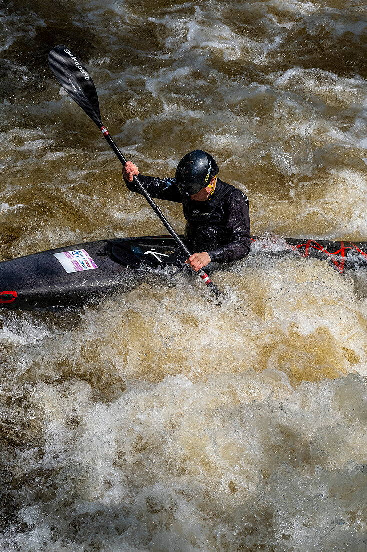A man kayaking on the Tryweryn river, National White Water Centre, canoeing watersports, near Bala, Wales