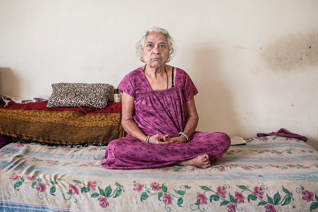 Portrait of Widow, in Ma Dham ashram for Widows of the NGO Guild for Service, the NGO proposes at widows to wear colorful clothes, Vrindavan, Mathura district, India