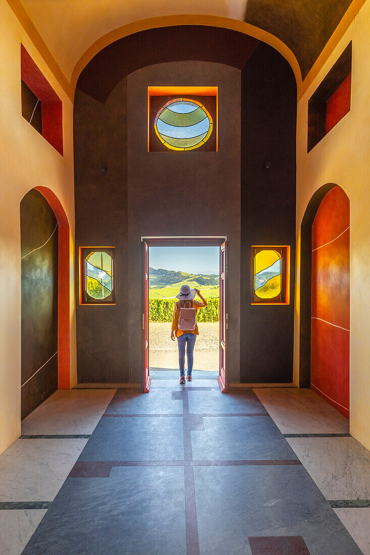 A woman inside Cappella del Barolo at sunset, La Morra, Cuneo, Langhe e Roero, Piedmont, Italy, Southern Europe (MR)