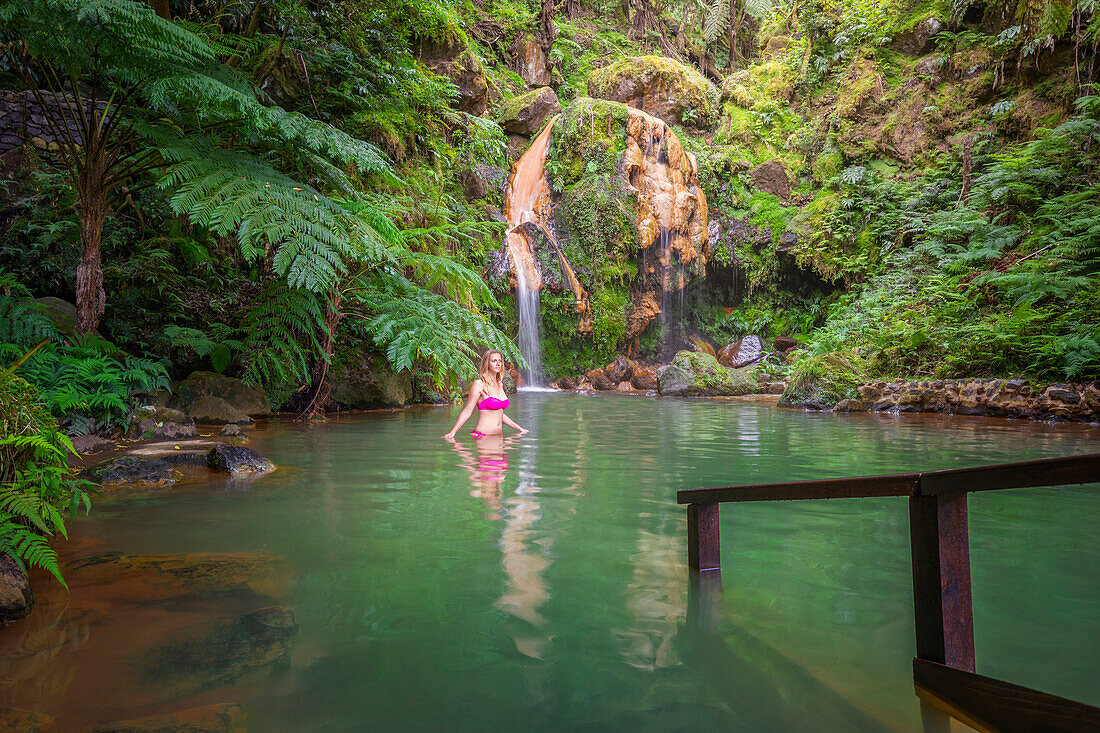 A woman in an hot springs of Caldeira Velha, Natural park, Ribeira Grande, Sao Miguel, Azores, Western Europe