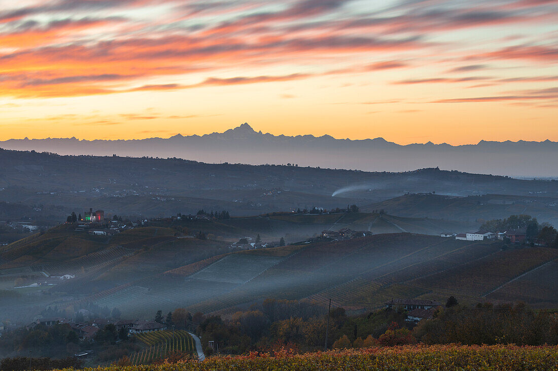 Grinzane Cavour Castle illuminated at sunset and Monviso in the distance, Cuneo, Langhe e Roero, Piedmont, Italy, Southern Europe