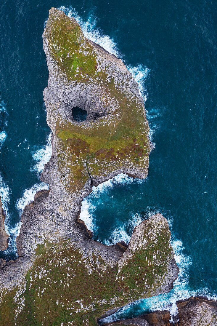 A cliff like a face at Area recreativa de Guadamia and Los Bufones de Pria at sunrise, Ribadesella, Asturias, Spain, Western Europe