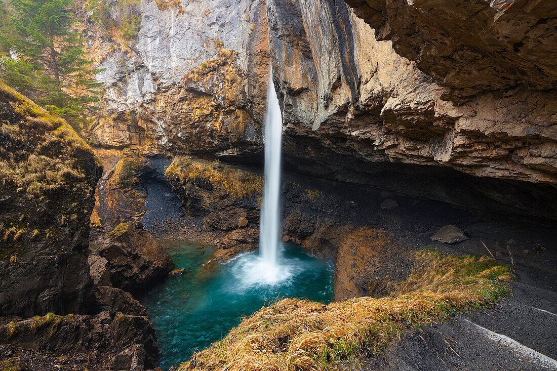 A person at Berglistuber waterfall during spring, Linthal Klausenpass, Cantone Glarona, Switzerland, Western Europe