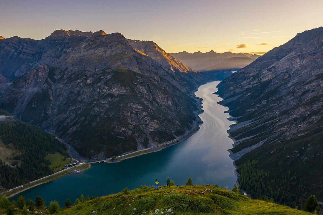 Aerial view of two guys at Crap de La Parè at sunrise, Livigno, Sondrio, Valtellina, Lombardy, Italy, Southern Europe