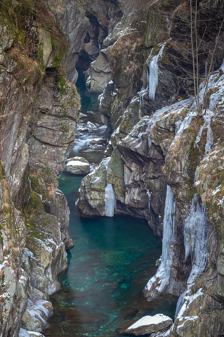 Die Orrido di Cossogno-Schlucht im Winter mit ihren vereisten Wasserfällen und dem Wildbach San Bernardino, gesehen von der römischen Brücke zwischen Cossogno und Rovegro. Val Grande, Bezirk Verbano Cusio Ossola, Piemont, Italien.