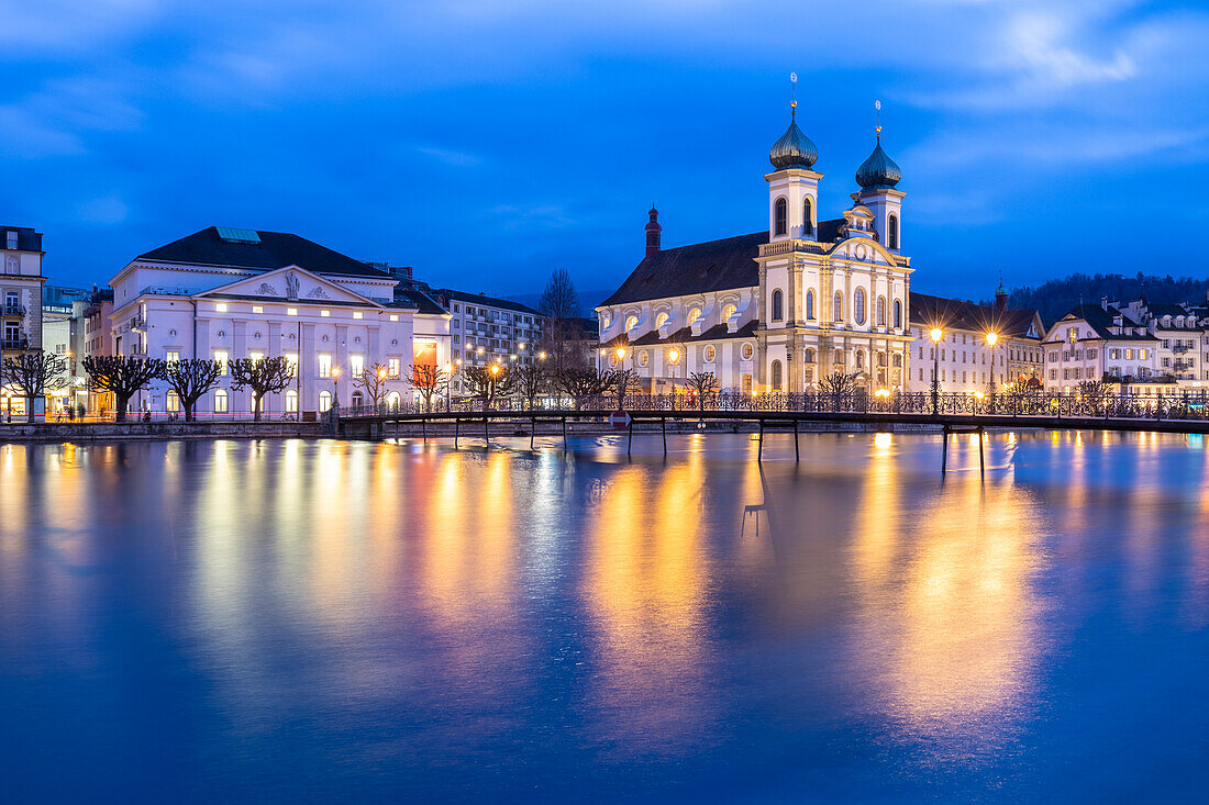 View of the Jesuit Church and the old town of Lucerne at blue hour reflected on the Reuss river. Lucerne, canton of Lucerne, Switzerland.